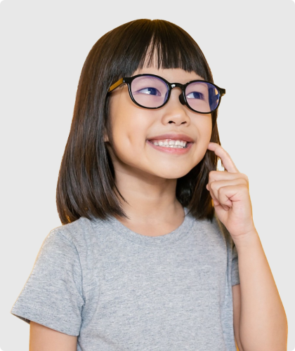 young girl in glasses pointing to her smile
