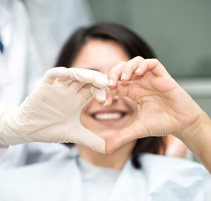 Girl With Orthodontist Making Heart Sign