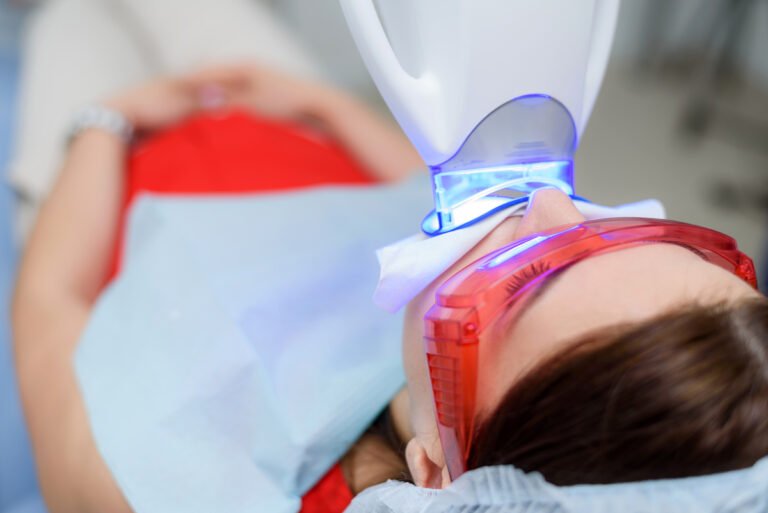 Female Orthodontic Patient Getting Teeth Whitened