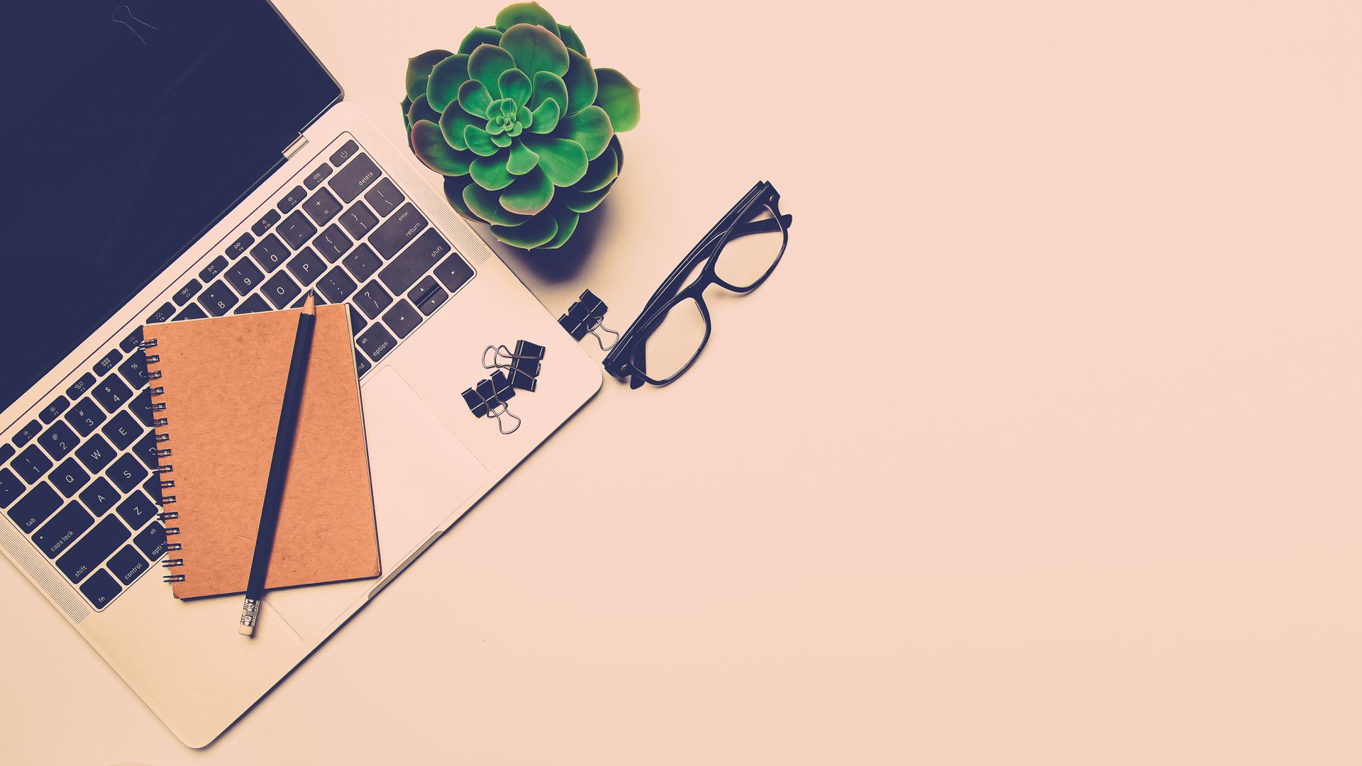 Laptop With Notebook And Glasses On Table