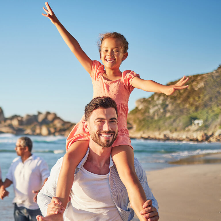 Smiling Daughter And Father On Beach